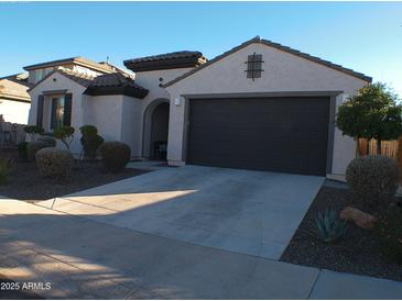 Single-story home with two-car garage and desert landscaping at 26035 W Quail Ave, Buckeye, AZ 85396