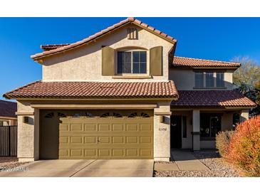 Two-story house with tan exterior, brown roof, and a two-car garage at 3496 E Anika Ct, Gilbert, AZ 85298