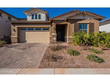 Single-story home with a two-car garage and landscaped front yard at 4466 N 200Th Ln, Litchfield Park, AZ 85340