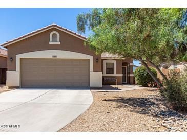 Single-story home with two-car garage and desert landscaping at 44899 W Portabello Rd, Maricopa, AZ 85139