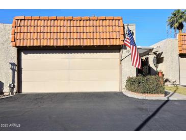 Attached garage with a Spanish-style tile roof at 5100 N Miller Rd # 20, Scottsdale, AZ 85250