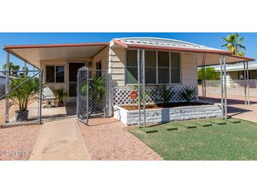 Cute single-wide manufactured home with carport and small front yard at 630 S 93Rd Pl, Mesa, AZ 85208