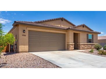 One-story house with a two-car garage and desert landscaping at 7110 E Gamebird Way, San Tan Valley, AZ 85143