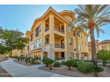 Luxury 3-story building with Spanish-style architecture, palm trees, and manicured landscaping at 7275 N Scottsdale Rd # 1001, Paradise Valley, AZ 85253