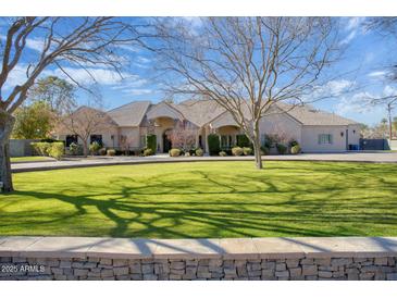 Elegant two-story home with a manicured lawn and circular driveway at 8220 N 15Th Ave, Phoenix, AZ 85021