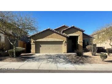 One-story house with tan exterior, two-car garage, and desert landscaping at 8498 W Maya Dr, Peoria, AZ 85383