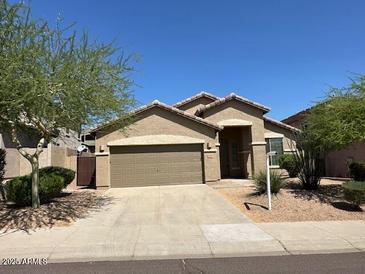 A single-story home featuring a two-car garage and desert landscaping against a clear blue sky at 8498 W Maya Dr, Peoria, AZ 85383