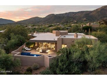 Luxury home with pool and patio, mountain backdrop at 10758 E Tamarisk Way, Scottsdale, AZ 85262
