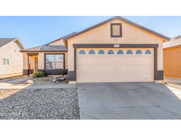 One-story house with a two-car garage and small front yard at 11793 W Larkspur Rd, El Mirage, AZ 85335