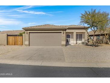 Charming single-story home showcasing a neutral color palette, a two-car garage, and desert landscaping at 14 E Peppergrass Pl, San Tan Valley, AZ 85143