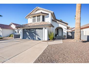 Two-story house with gray garage doors and a landscaped front yard at 1436 E Rosemonte Dr, Phoenix, AZ 85024