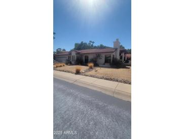 Single-story home with desert landscaping and a long driveway at 15829 N 12Th St, Phoenix, AZ 85022