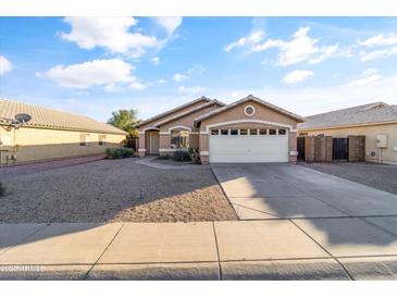 Single story home with attached garage and desert landscaping at 15913 W Elm St, Surprise, AZ 85374