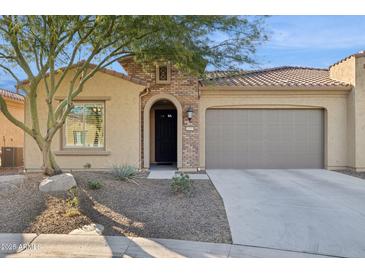 Single-story home with a two-car garage and desert landscaping at 16955 W Holly St, Goodyear, AZ 85395