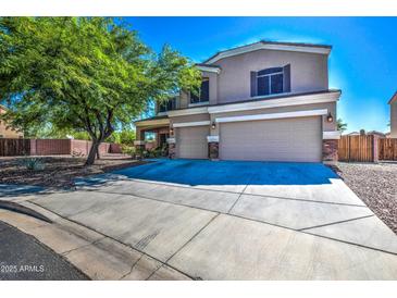 Two-story house with a large driveway and landscaped yard at 1839 S 219Th Dr, Buckeye, AZ 85326