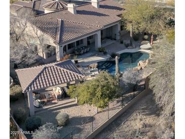 Backyard oasis with a sparkling pool, covered patio, and lush landscaping at 32029 N 19Th Ln, Phoenix, AZ 85085