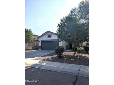 Single-story home with a two-car garage and mature landscaping at 35801 N Zachary Rd, San Tan Valley, AZ 85144