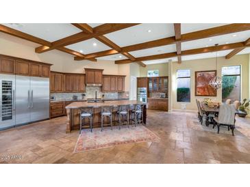 Spacious kitchen with large island, stainless steel appliances, and wood beams at 7575 E Camino Salida Del Sol --, Scottsdale, AZ 85266