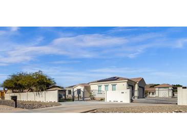 House exterior featuring solar panels and gated entrance at 8308 W Avenida Del Sol --, Peoria, AZ 85383