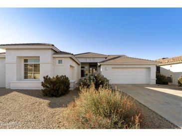 Single-story home with white exterior, two-car garage, and desert landscaping at 9323 E Arrowvale Dr, Sun Lakes, AZ 85248