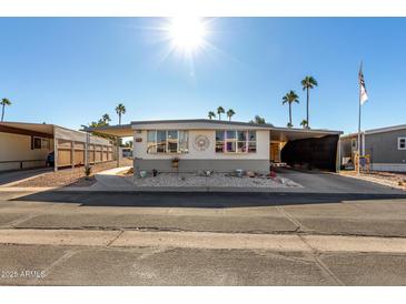 Single-wide manufactured home with carport and small front yard at 9501 E Broadway Rd # 178, Mesa, AZ 85208