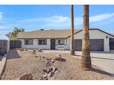 Updated single-story home with a landscaped front yard and two-car garage at 1104 N Oak Ct, Gilbert, AZ 85233