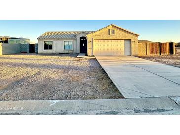 Single-story house with a two-car garage and a gravel driveway at 13943 S Amado Blvd, Arizona City, AZ 85123