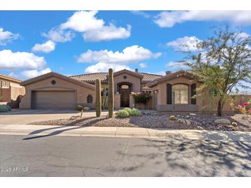 Single-story home with desert landscaping and a three-car garage at 2223 W Hazelhurst Ct, Anthem, AZ 85086