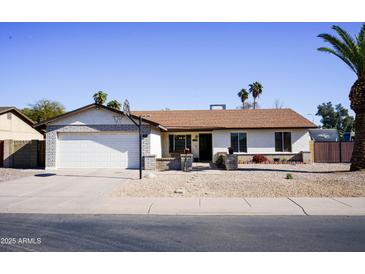 Single-story house with a two-car garage, and a basketball hoop at 2300 W Temple St, Chandler, AZ 85224