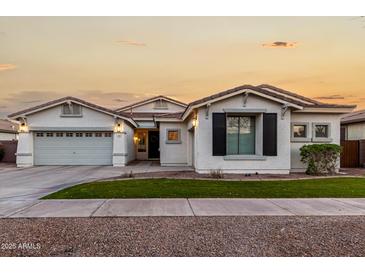 Two-story house with white exterior, landscaped lawn, and a two-car garage at 255 W Seagull Pl, Chandler, AZ 85286