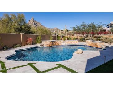 Luxury pool with a waterfall feature and mountain views at 25838 N 104Th Pl, Scottsdale, AZ 85255