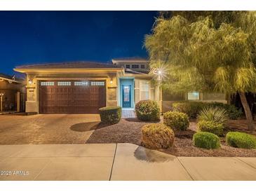 Attractive single-story home with landscaped front yard at night at 27648 N 102Nd Ln, Peoria, AZ 85383