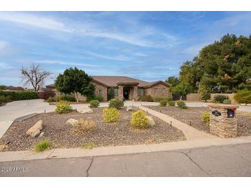 Single-story home with stone accents and landscaped front yard at 280 N 159Th St, Gilbert, AZ 85234