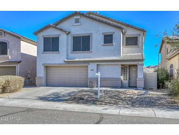 Two-story house with beige exterior, two-car garage, and landscaping at 28025 N 23Rd Dr, Phoenix, AZ 85085