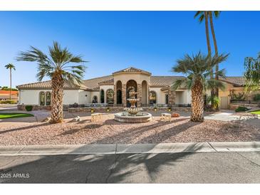 Stunning desert home with a fountain and palm trees at 3611 E Kachina Dr, Phoenix, AZ 85044