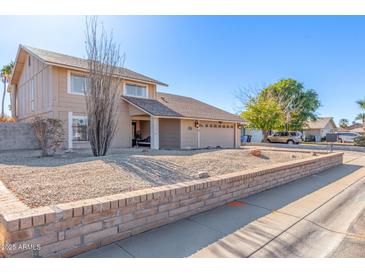 Two-story house with a landscaped yard and two-car garage at 4129 W Hearn Rd, Phoenix, AZ 85053