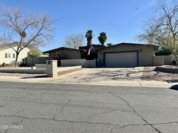 Charming single-story home with a well-manicured lawn and an inviting, wide driveway at 511 E Port Au Prince Ln, Phoenix, AZ 85022