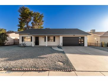 Updated single-story home with modern garage door and gravel landscaping at 5315 W Christy Dr, Glendale, AZ 85304