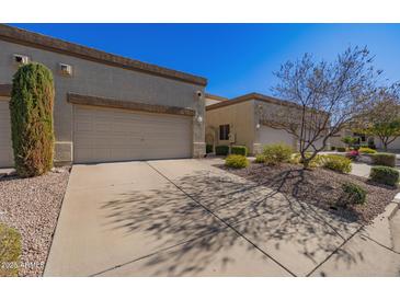 Front view of charming home with two-car garage and well-manicured landscaping at 6730 E Hermosa Vista Dr # 75, Mesa, AZ 85215