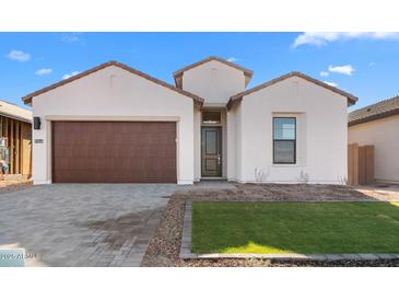 One-story home with brown garage door and landscaped lawn at 699 E Greenback Dr, San Tan Valley, AZ 85140