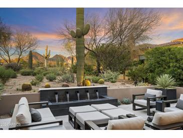 Desert landscape with patio furniture, water feature, & mountain views at 9280 E Thompson Peak Pkwy # 15, Scottsdale, AZ 85255