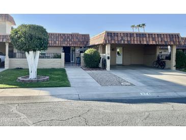 Attractive single-story home with carport and well-manicured landscaping at 9746 N 105Th Dr, Sun City, AZ 85351