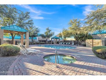 Community pool and spa area with lounge chairs and shaded seating at 1015 S Val Vista Dr # 87, Mesa, AZ 85204