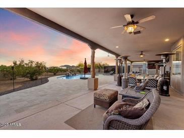 Spacious backyard with a sparkling pool, patio furniture, and stunning sunset views at 103 W Tanya Rd, Phoenix, AZ 85086