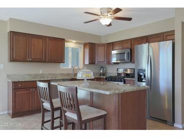 Modern kitchen with granite countertops and stainless steel appliances at 11453 N 24Th Dr, Phoenix, AZ 85029