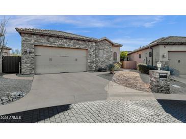 Craftsman style home with stone accents and a two-car garage at 11729 N 134Th St, Scottsdale, AZ 85259