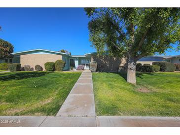 Ranch-style home with well-maintained lawn and walkway at 17318 N Del Webb Blvd, Sun City, AZ 85373