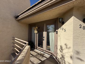 Inviting condo entrance with double doors and gold bow at 1832 N 52Nd St # 205, Phoenix, AZ 85008