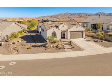 Single-story home with desert landscaping and a two-car garage at 18873 N 262Nd Dr, Buckeye, AZ 85396