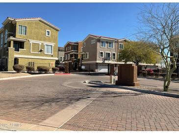 Exterior view of community entrance with paved road and gated access at 22125 N 29Th Ave # 127, Phoenix, AZ 85027